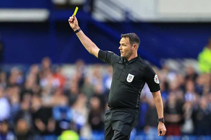 James Linington dishing out a yellow card to Ross Stewart in last season's play-off semi-final against Sheffield Wednesday.